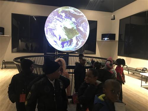 Students looking at Globe 